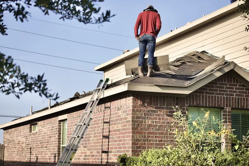 Professional roofer working on a residential roof in Plano